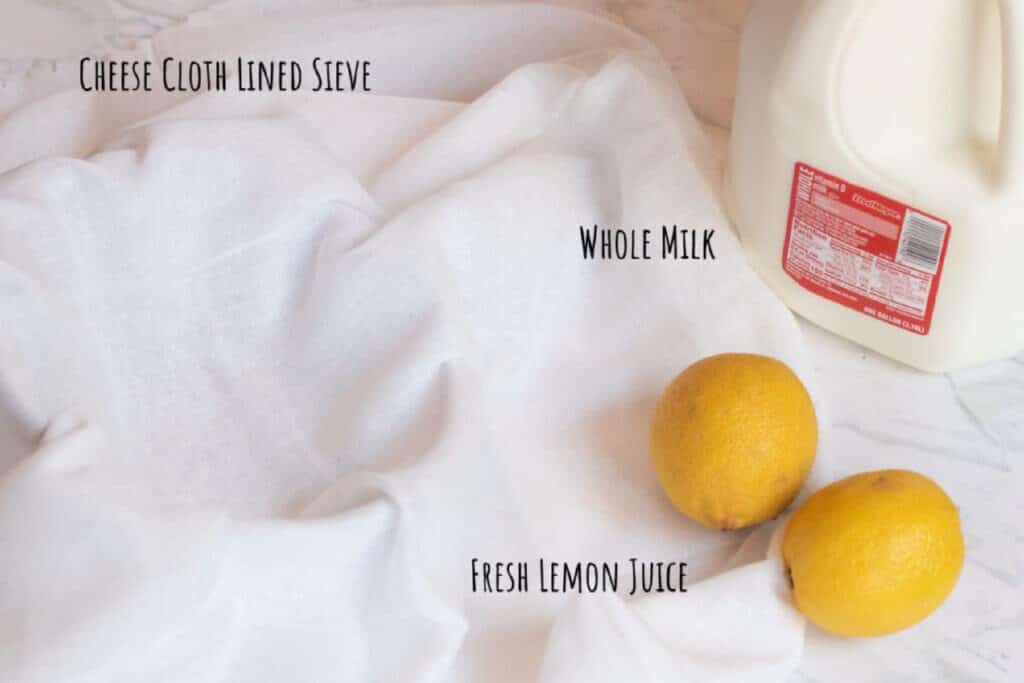 a sieve lined cheesecloth, gallon of milk, and lemons labeled.