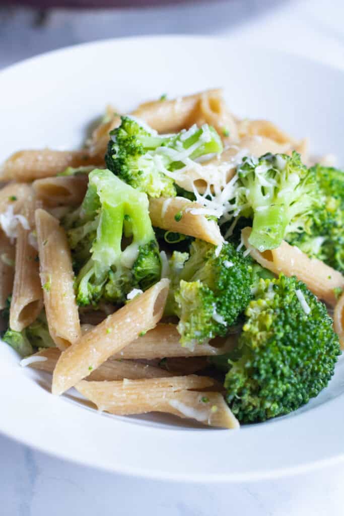 a plate of cooked penne and broccoli