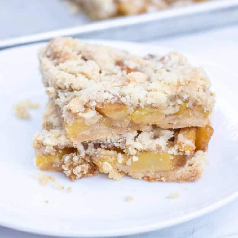 a plate with crumble bars with what looks like apples.