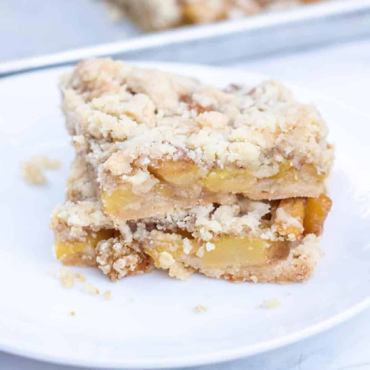 a plate with crumble bars with what looks like apples.