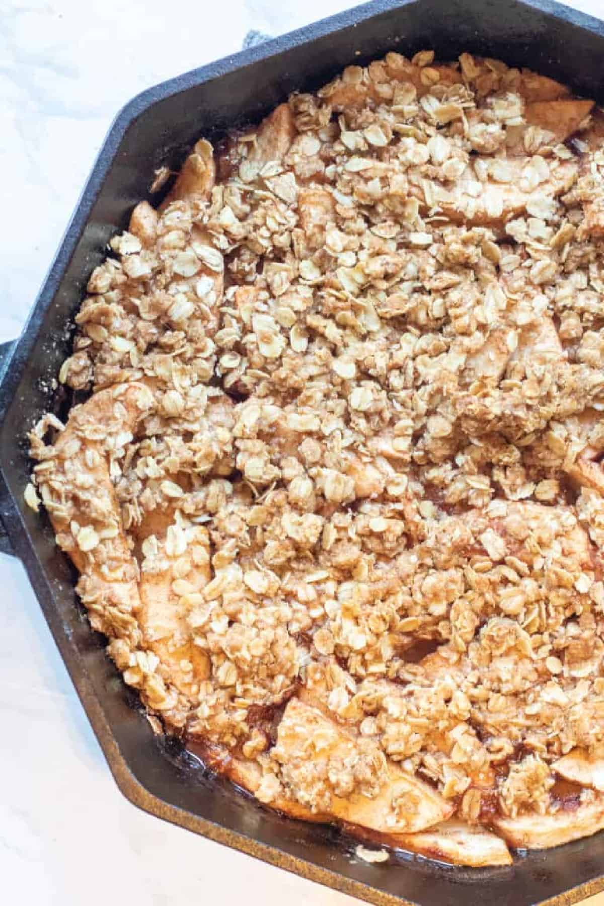 baked apple crisp in a cast iron.