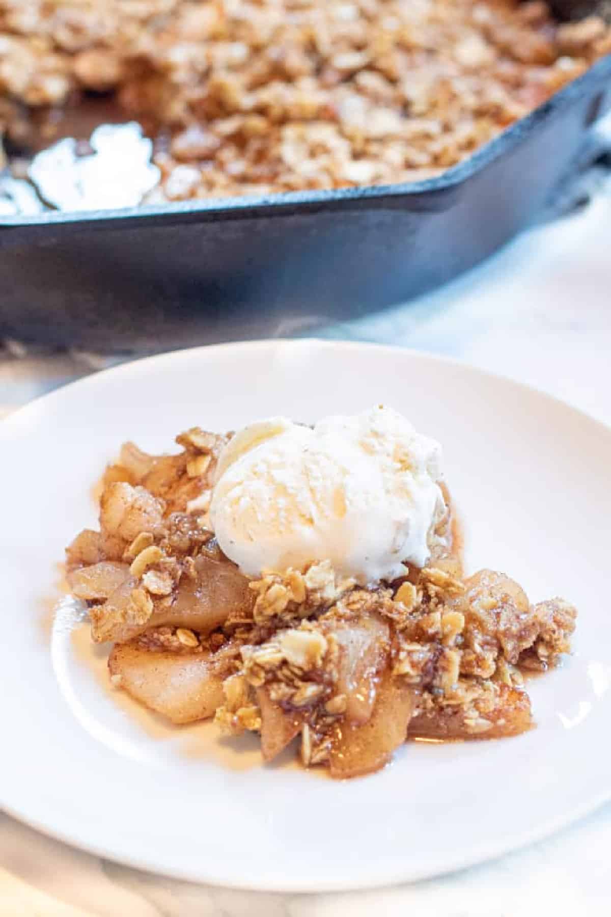 a plate of apple crisp with ice cream on top