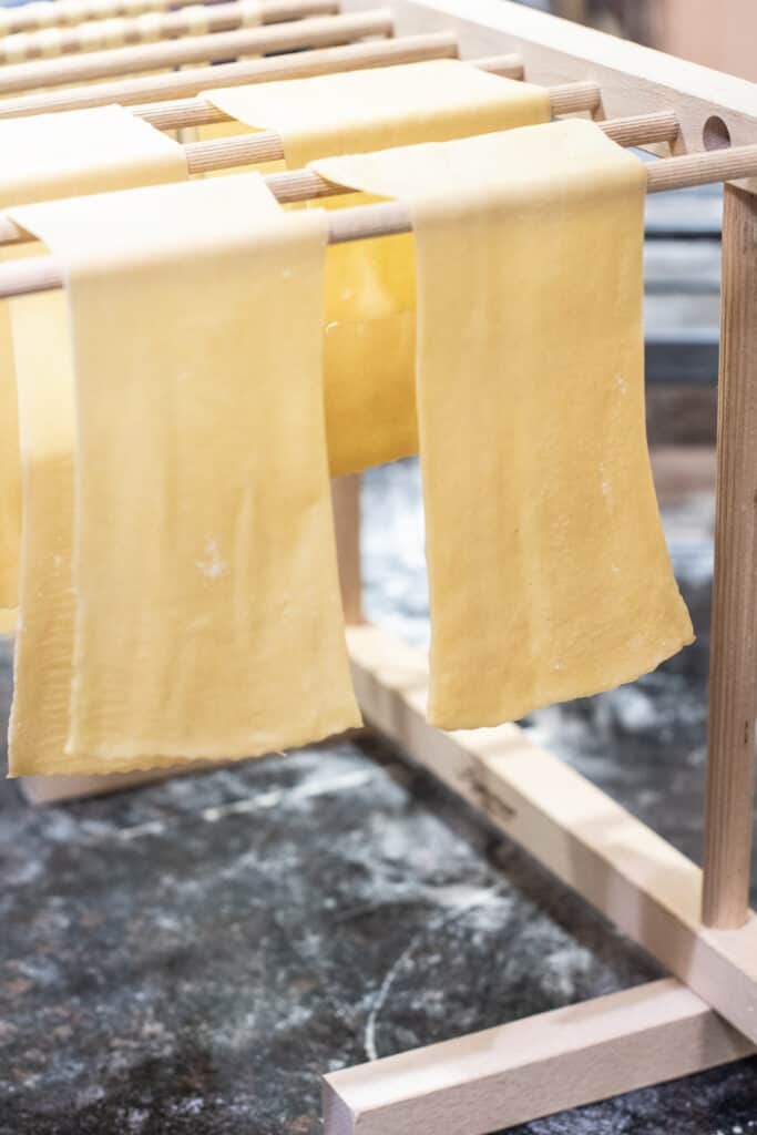 lasagna noodles drying on a pasta rack