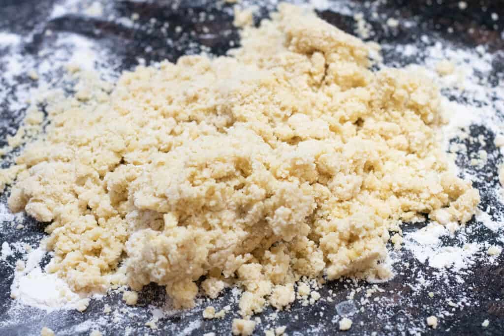 crumbled dough on a floured counter