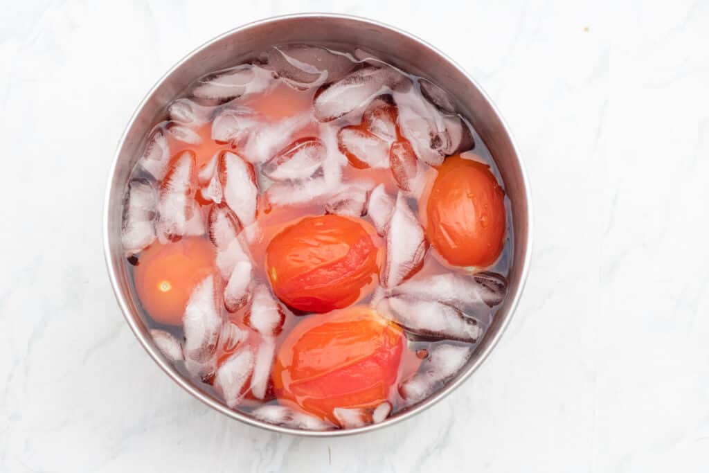 tomatoes in an ice bath in a bowl