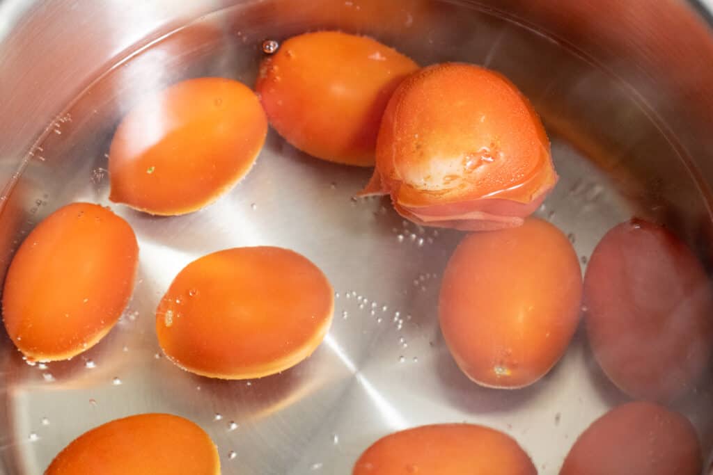 whole tomatoes in water in a pot