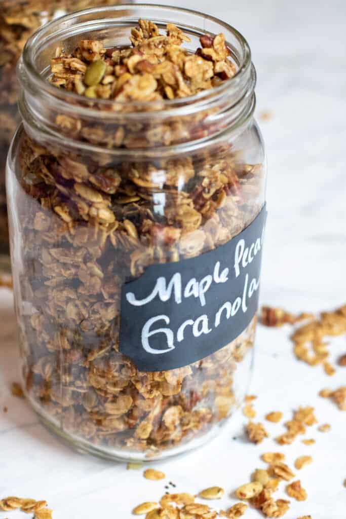 a close up of a large mason jar of granola 