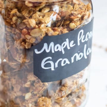 a close up of a large mason jar with granola.