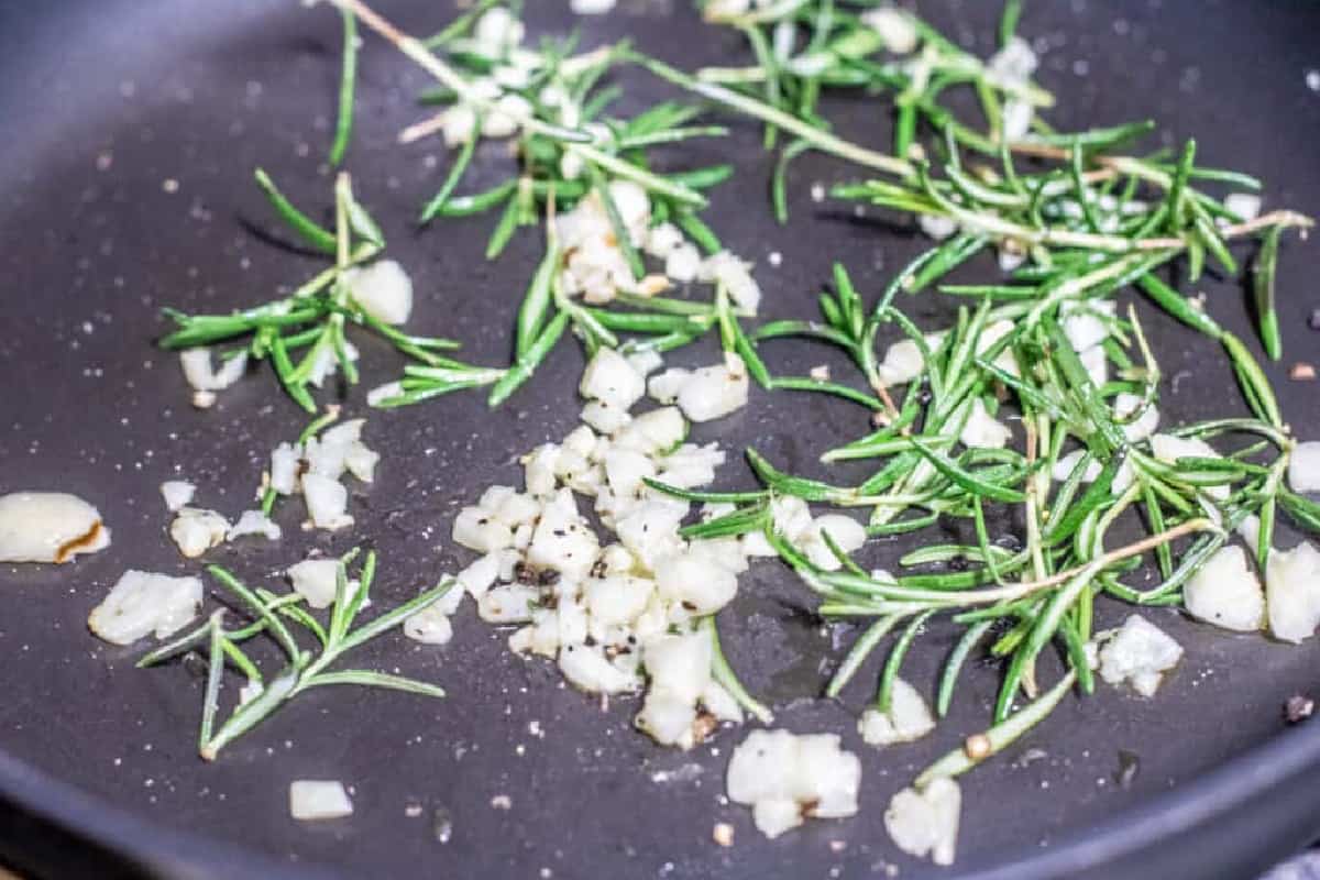 garlic and rosemary in a pan.