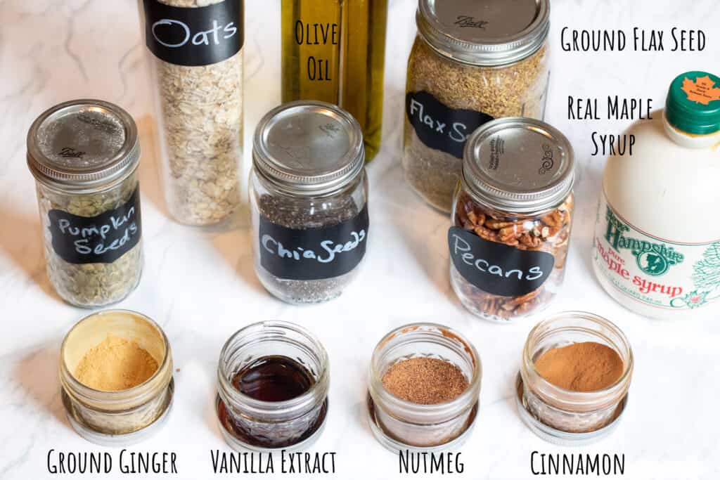 oats, nuts, seeds, maple, and spices on a counter