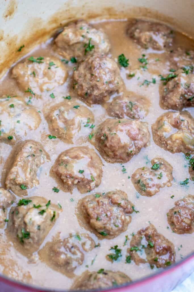 cooked meatballs in a pot in gravy