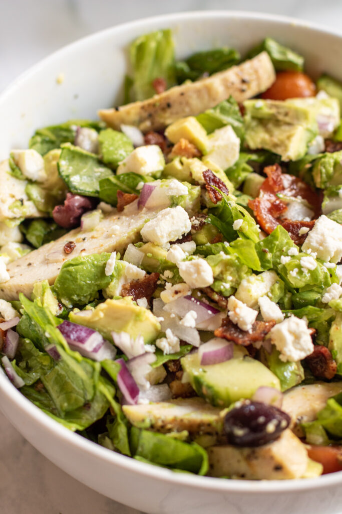 a bowl of salad with chicken.