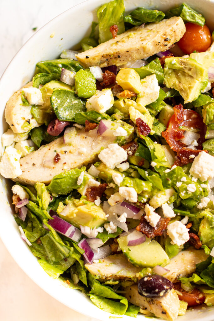 a bowl of sliced chicken and salad.