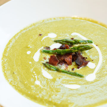 bowl of soup with bacon and asparagus and cream.