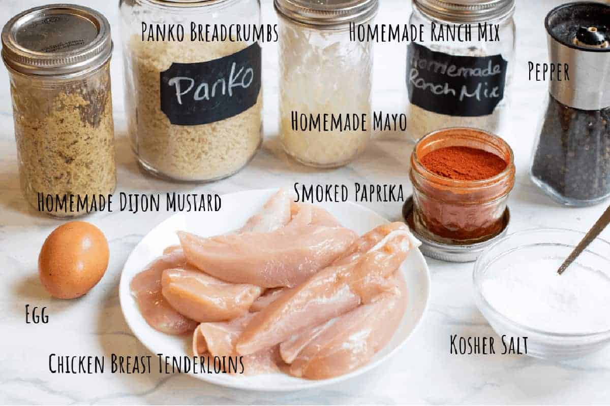 jars of mustard, panko, raw chicken tenders, egg, spices, salt, and pepper labeled.