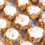 cooked cookies with frosting on cooling rack.