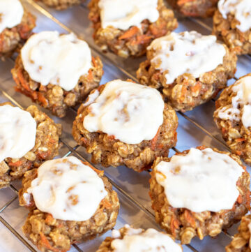 cooked cookies with frosting on cooling rack.