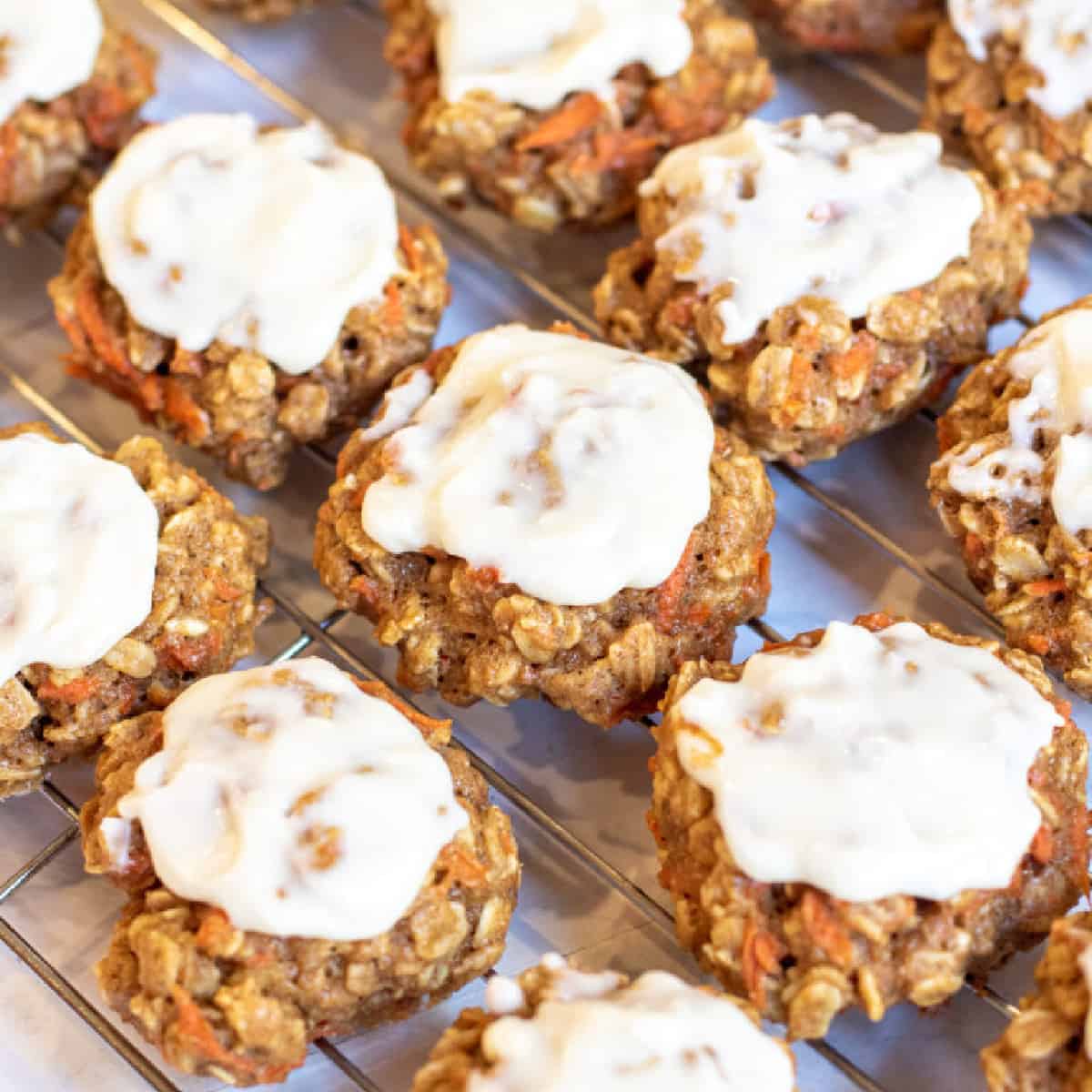 a cooling rack of frosting cookies.