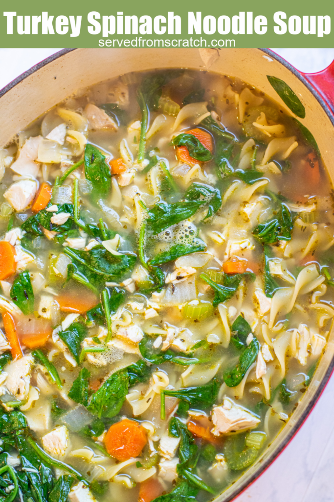 dutch oven of noodle spinach soup with Pinterest pin text.