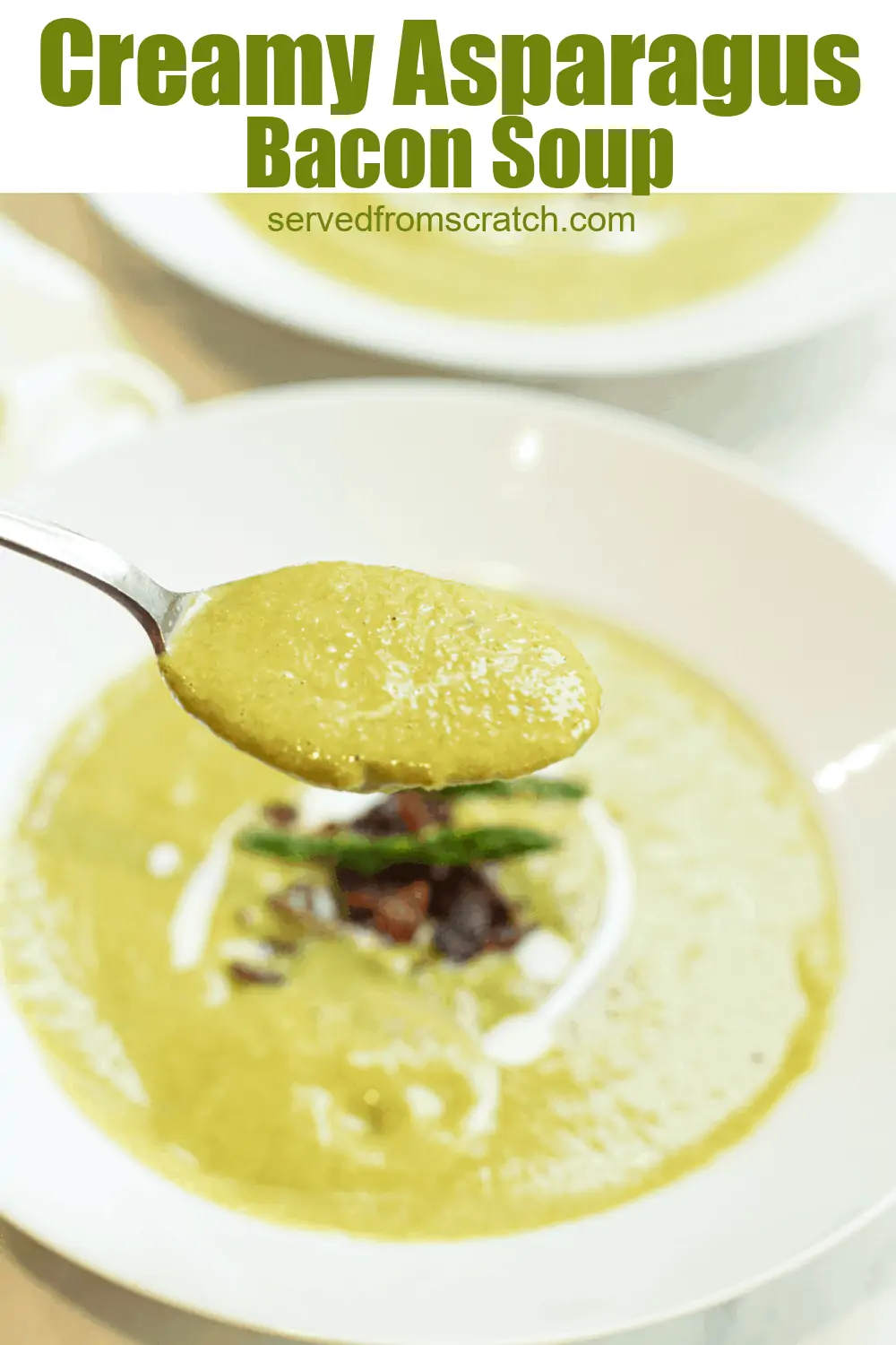 a close up of a bowl of creamy green soup with asparagus and bacon on top.