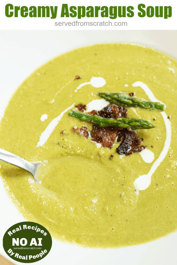 a close up of a bowl of creamy green soup with asparagus and bacon on top with Pinterest pin text and NO AI sticker.