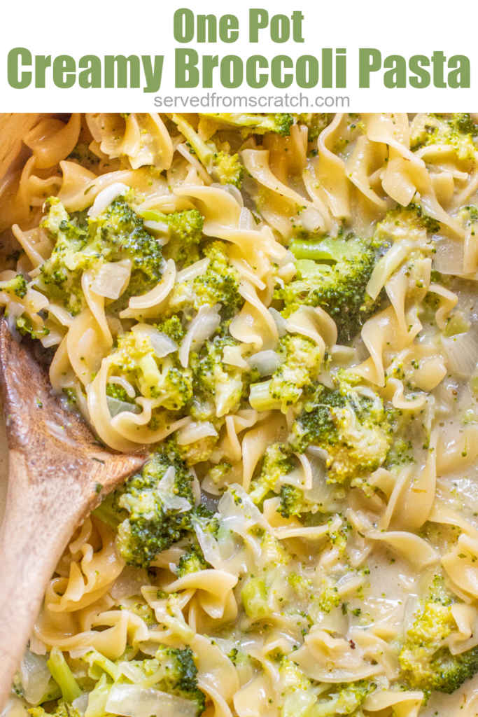 overhead of a wooden spoon in a creamy pot of pasta with broccoli with pinterest text.