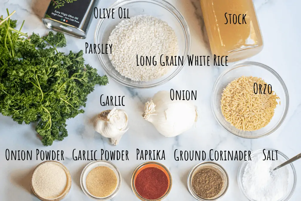 parsley, olive oil, stock, rice, orzo, spices, garlic, and onion on a counter.