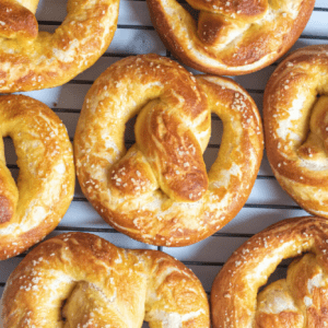 close up of a soft pretzel on a cooling rack.