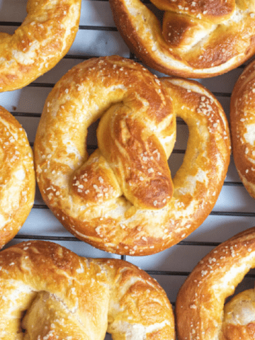 close up of a soft pretzel on a cooling rack.