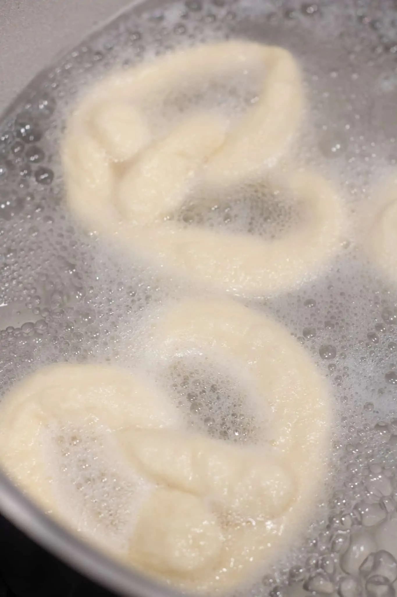 close up of a soft pretzel on a cooling rack.