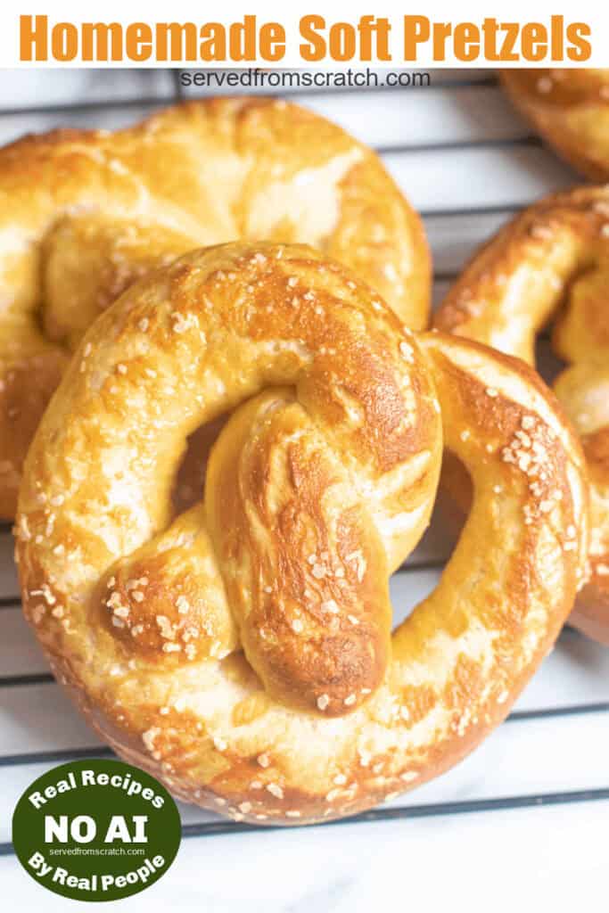 close up of a soft pretzel on a cooling rack with Pinterest pin text and a NO AI sticker.