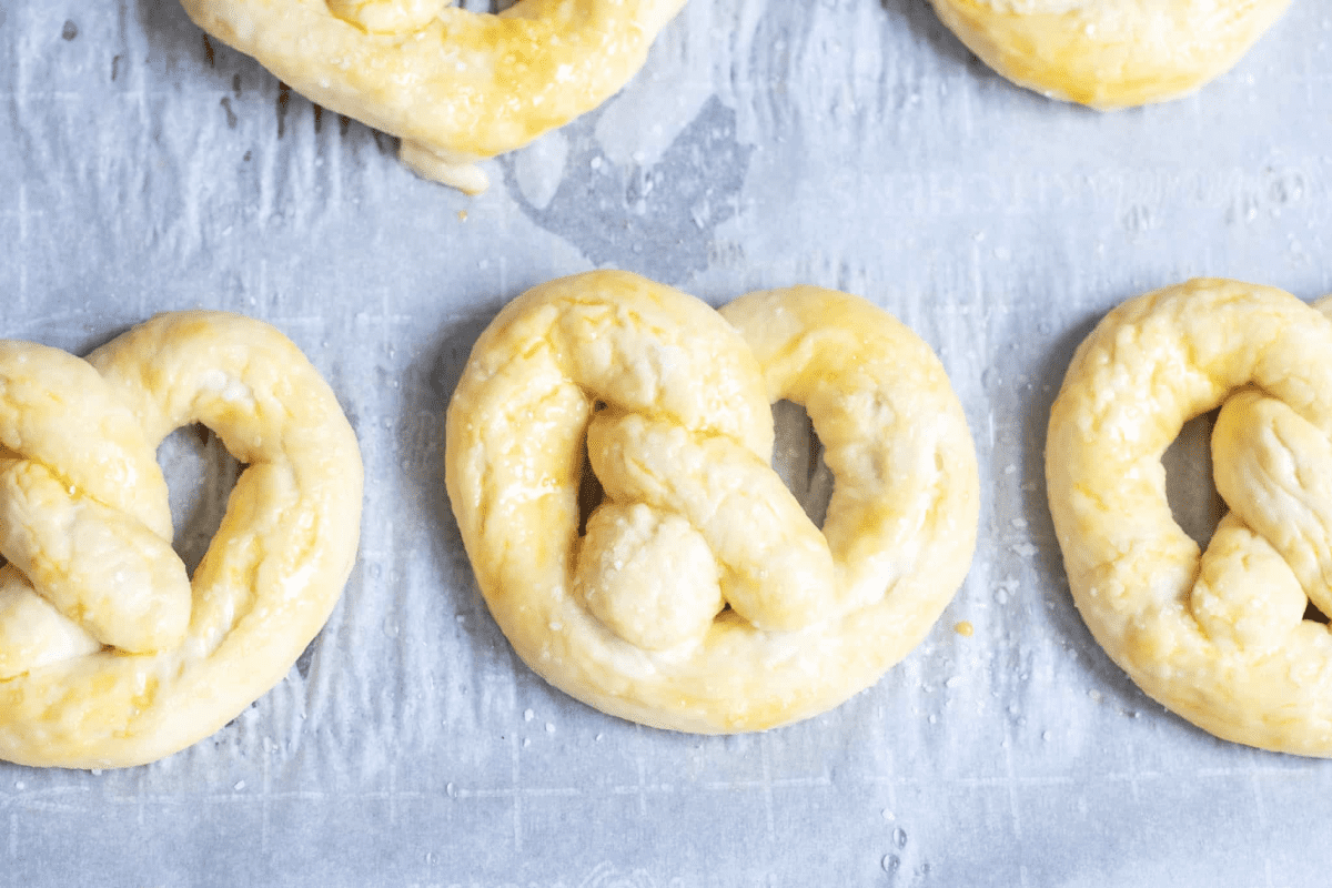 unbaked pretzels on parchment paper.