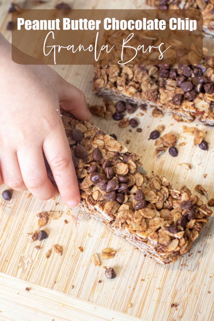 a kids hand grabbing a chocolate chip granola bar and pinterest text.