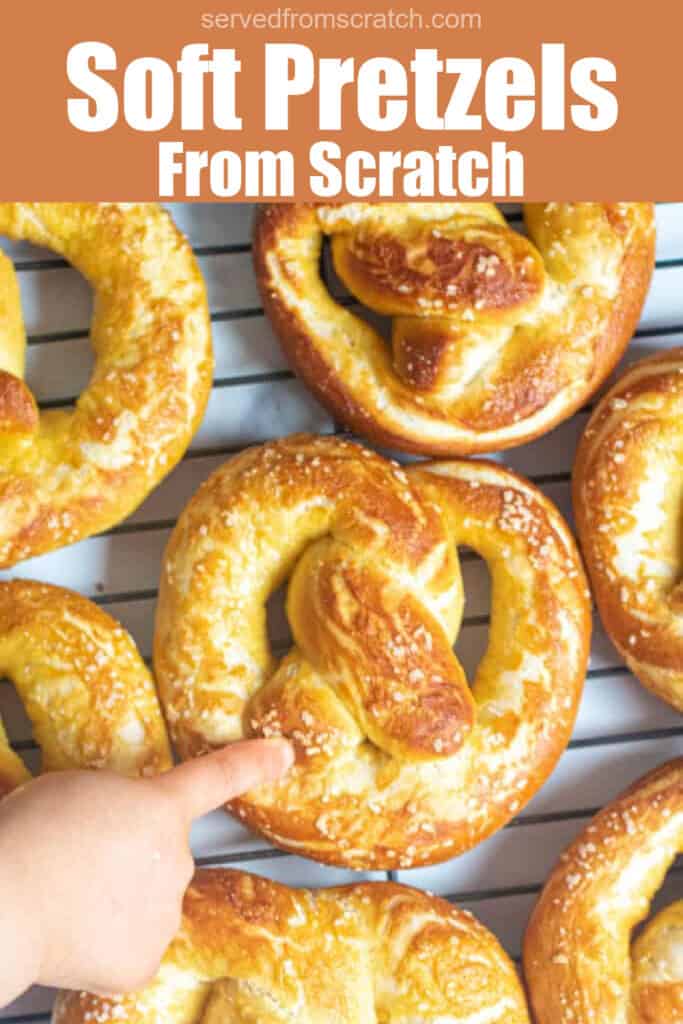 little hand pointing to a fresh baked pretzel with Pinterest pin text.