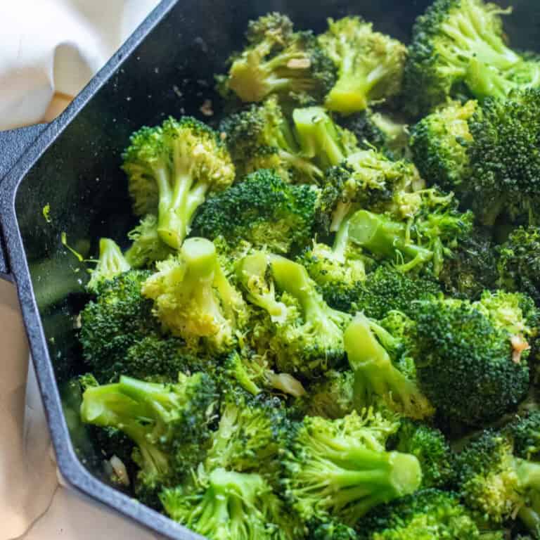 a cast iron with cooked broccoli florets.