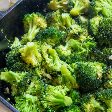 cooked broccoli and garlic in a cast iron.