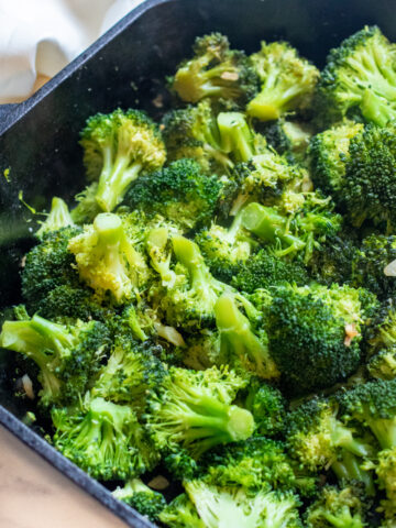 cooked broccoli and garlic in a cast iron.