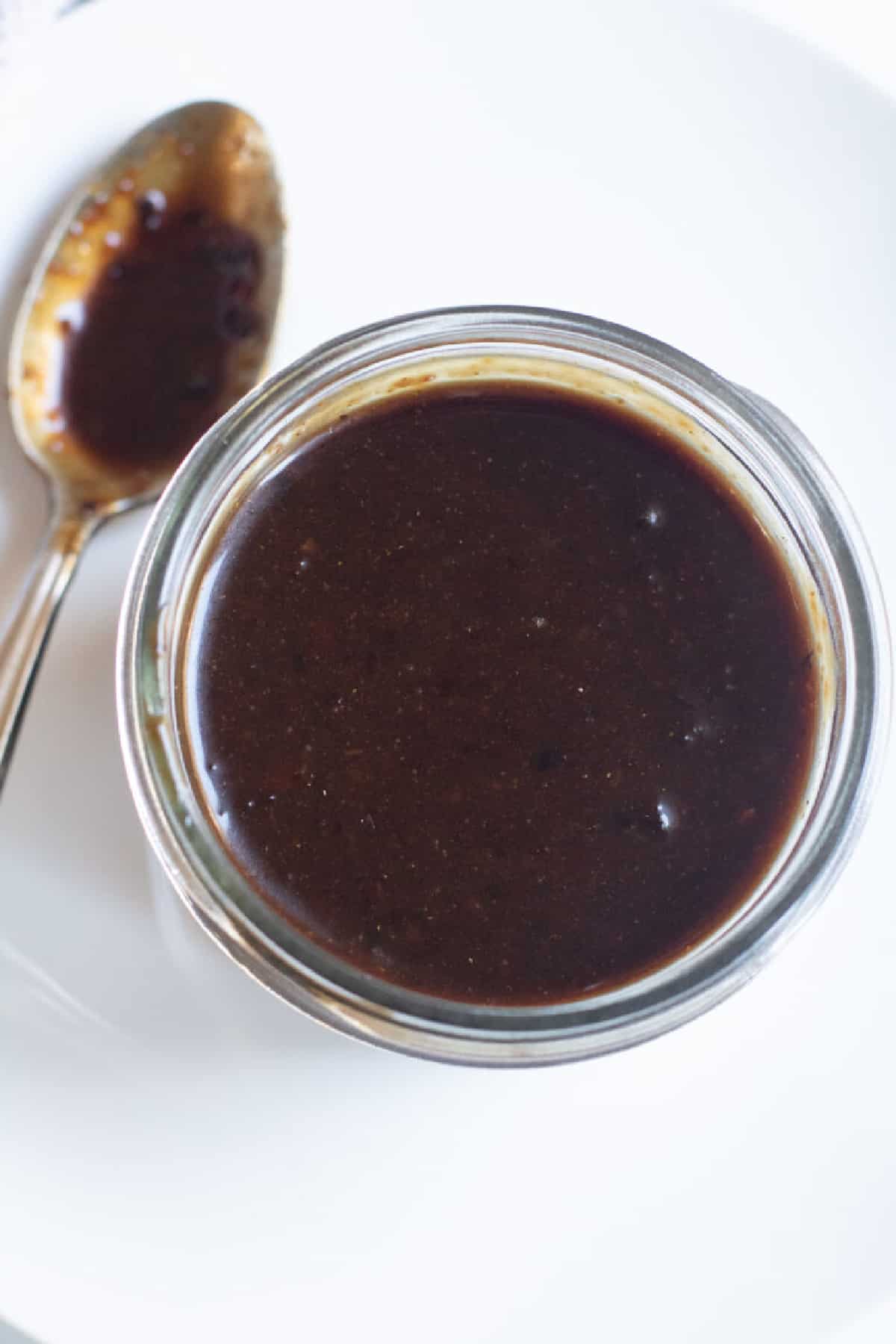 an open small mason jar of hoisin sauce.