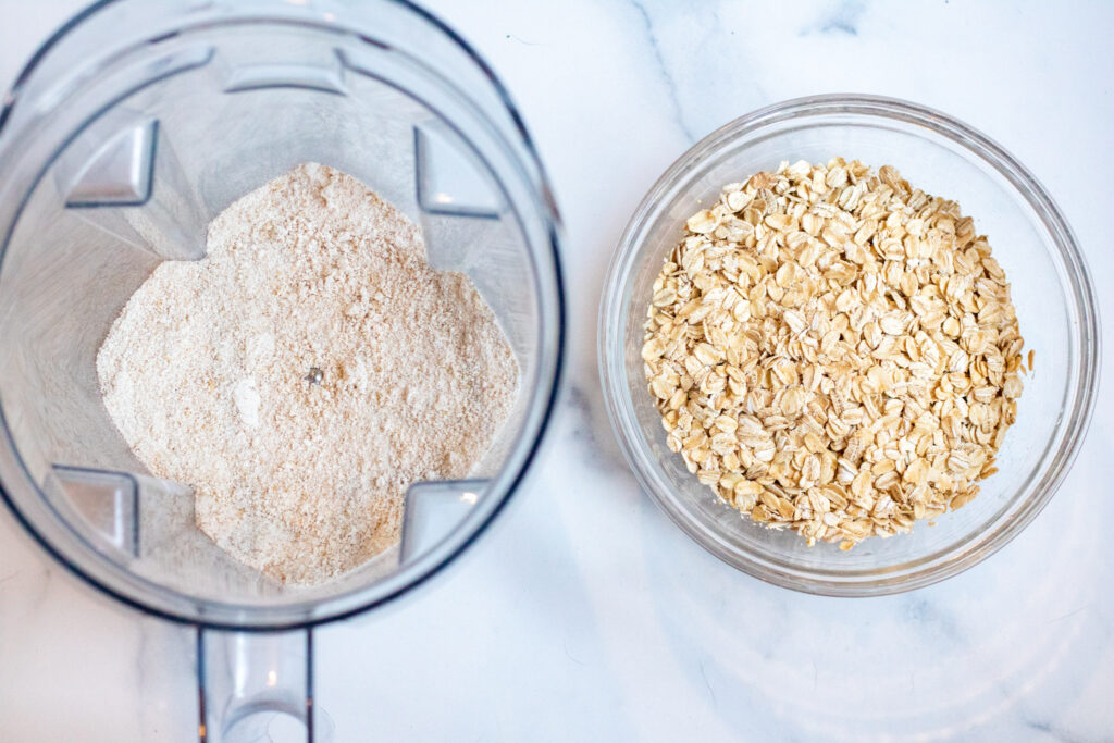 a blender with oat flour and a bowl of oats.