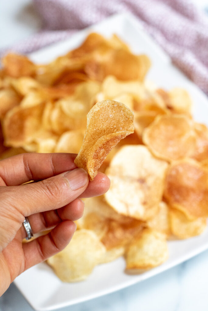 a plate of thin crispy potato chips.