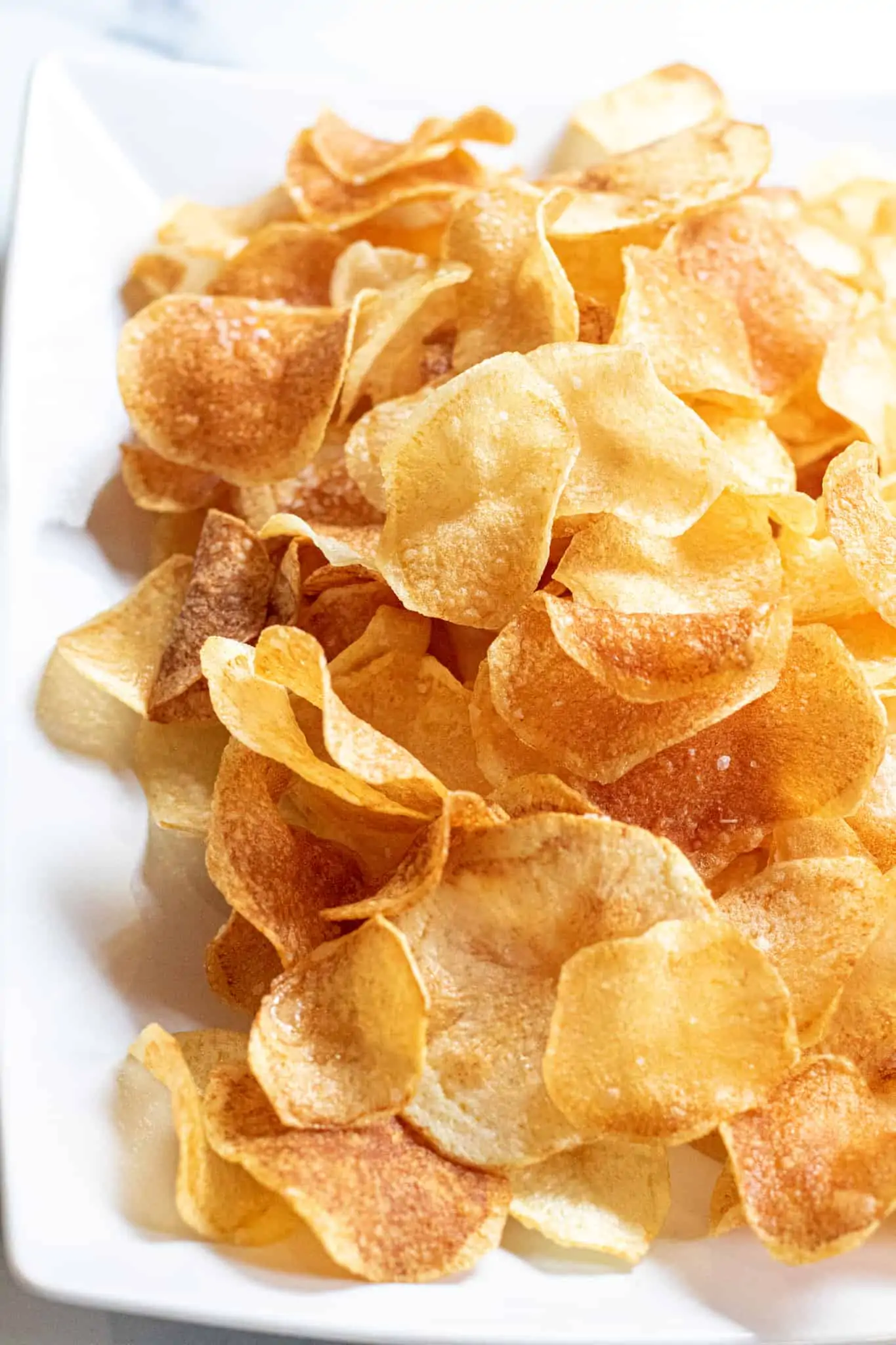 a plate of thin crispy potato chips.