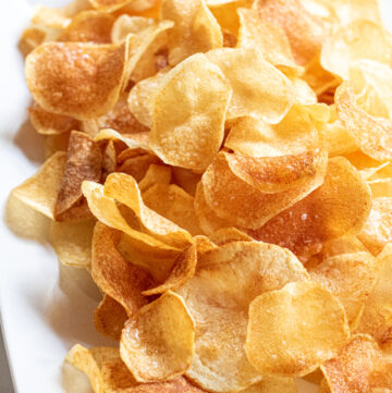 a plate of thin crispy potato chips.