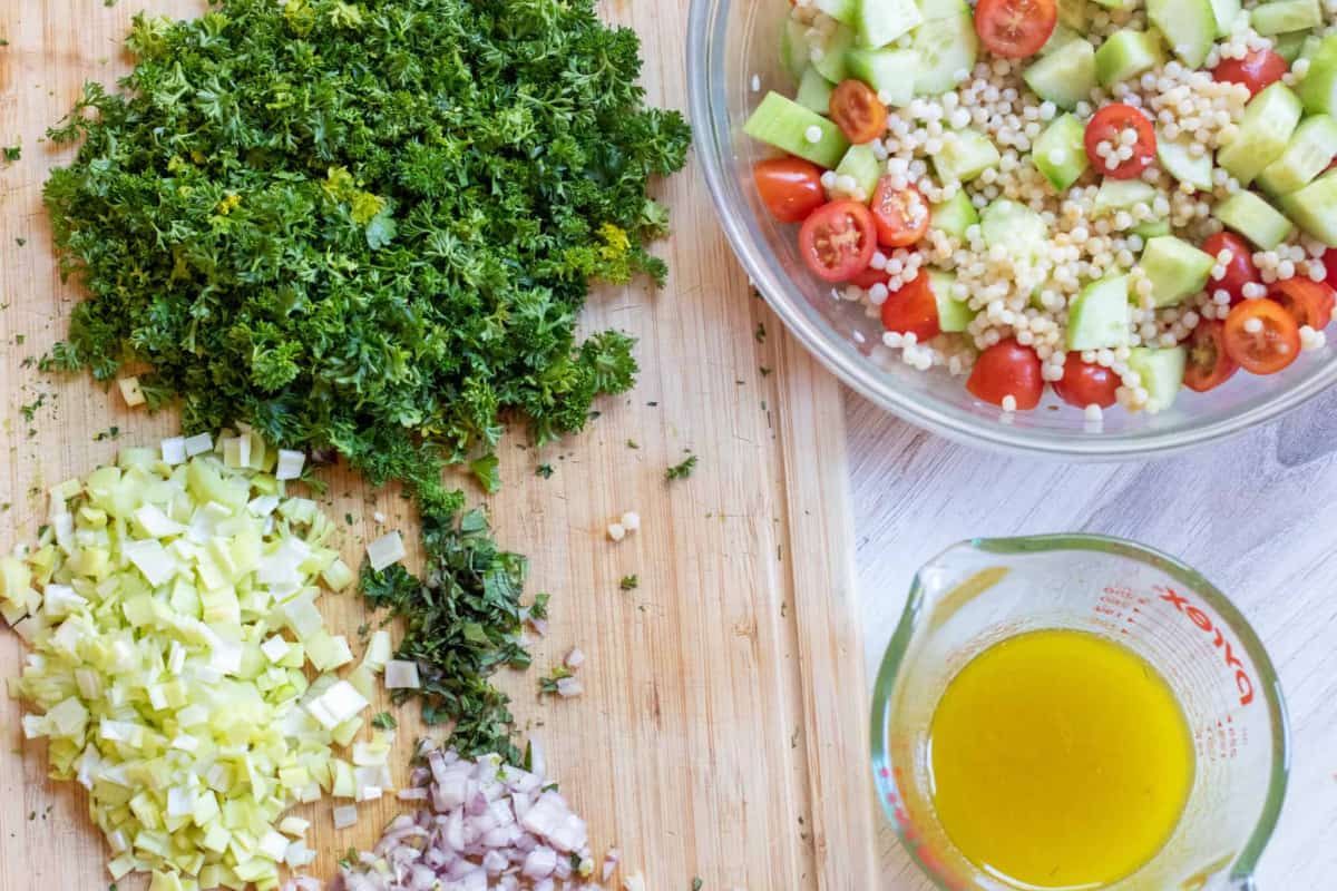 parsley, leeks, shallots, and a bowl of cucumbers, couscous, and a vinaigrette.