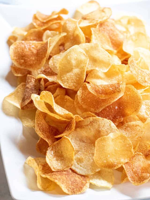 a plate of thin crispy potato chips.