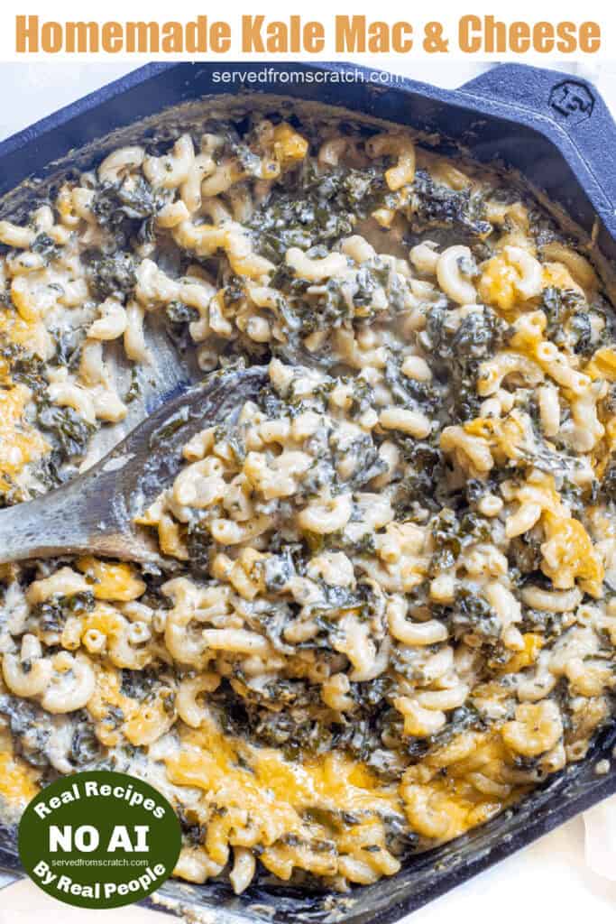 a cast iron skillet with mac n cheese with kale and a wooden spoon with Pinterest pin text with NO AI sticker.