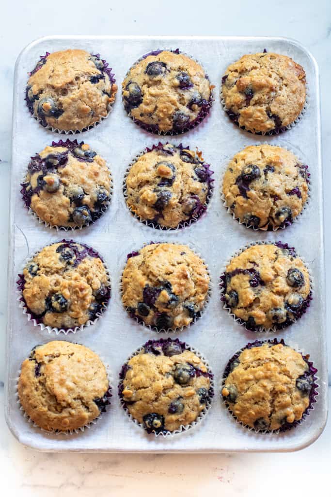 a muffin tin of blueberry muffins.
