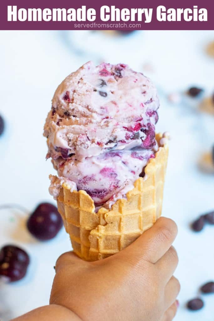 a hand holding an ice cream cone.