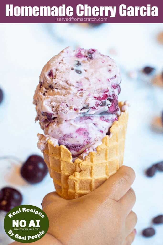 a hand holding an ice cream cone with cherry garcia ice cream and a NO AI sticker.