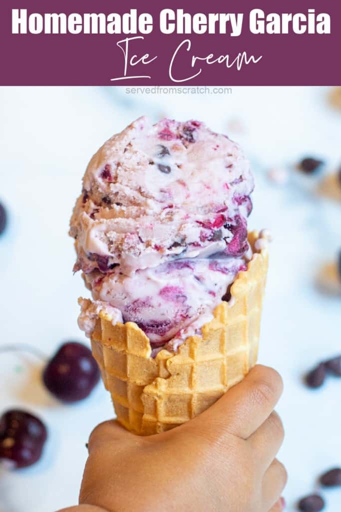 a hand holding an ice cream cone.