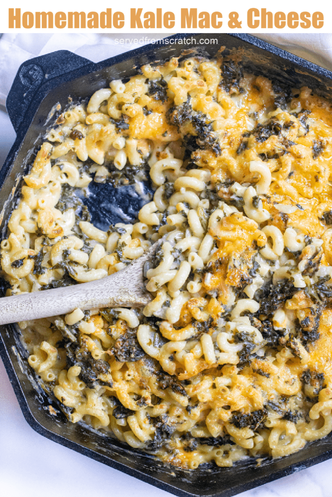 a spoon scooping some mac and cheese with kale with Pinterest pin text.